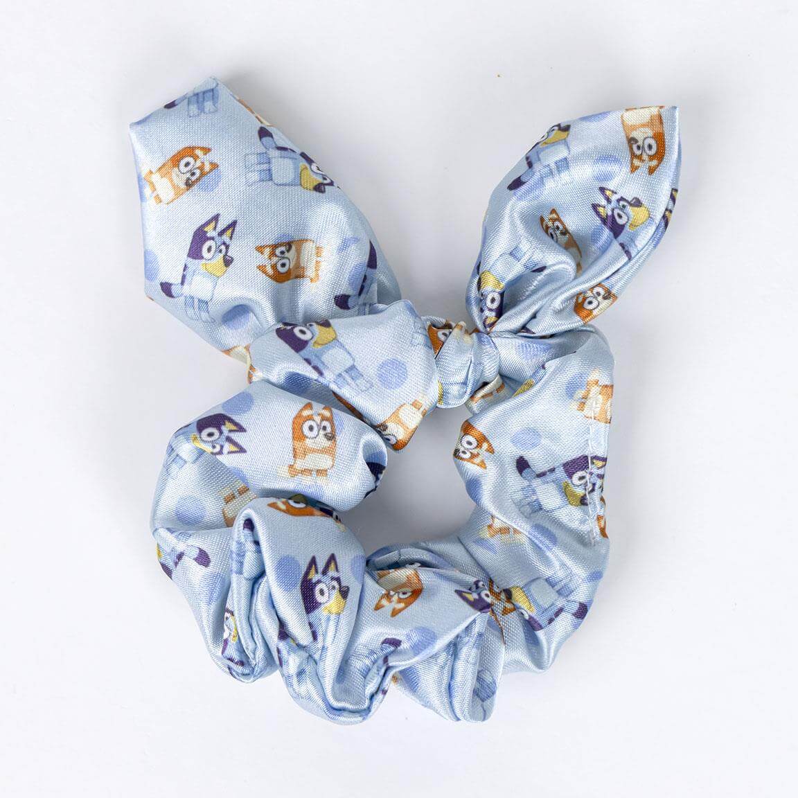 Bluey-themed hair scrunchie with colorful character prints on a light blue fabric.