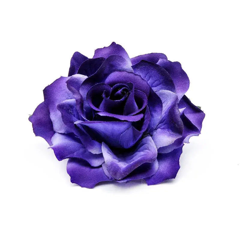 Purple artificial rose flower close-up on white background.