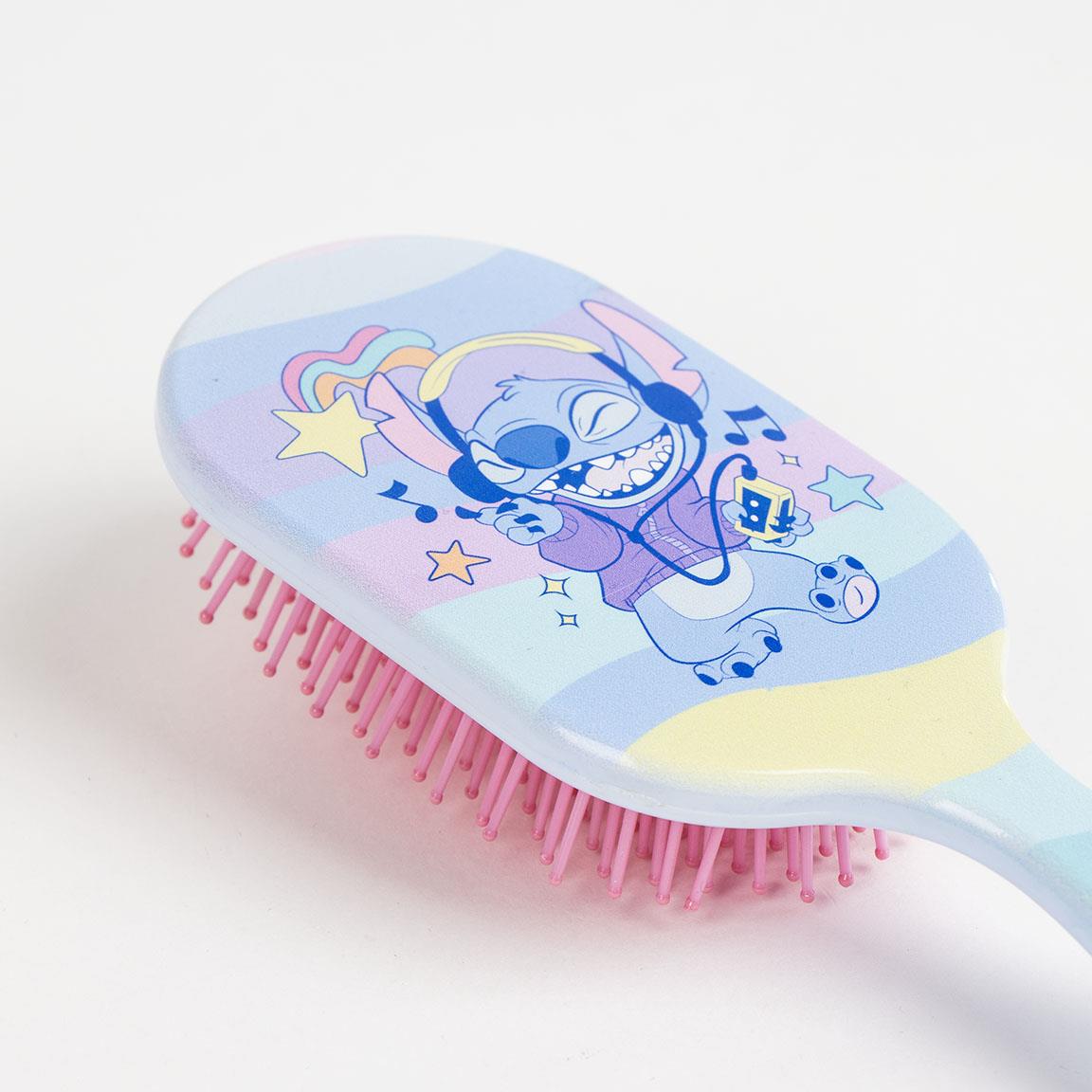 Colorful hairbrush featuring a playful cartoon character design with music notes and stars, perfect for kids.