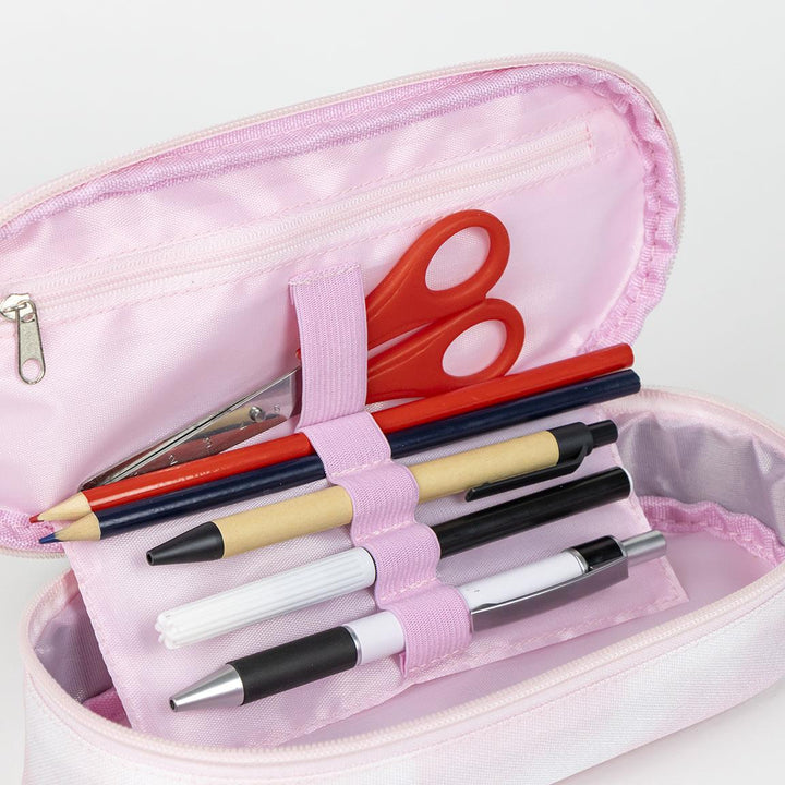 Pink pencil case with pens, pencils, and red scissors inside, showcasing organized school supplies.